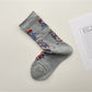 Rufia mesh floral mid-calf socks worn on feet showing mid-calf length and floral pattern