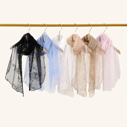 Scarvii delicate sheer floral wrap laid out with edges and floral details visible