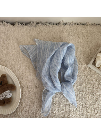 Soft check bandana scarf draped over a wooden surface