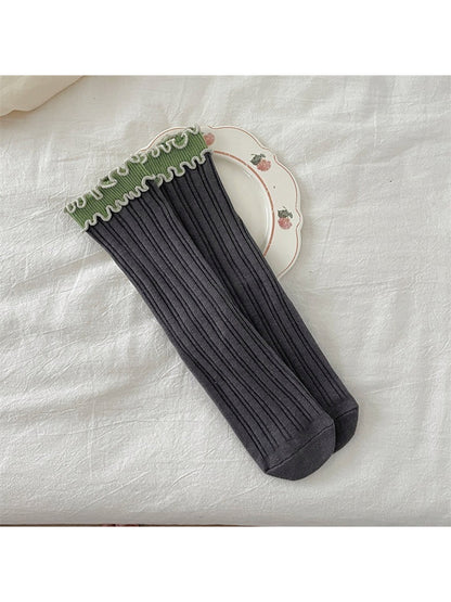 Top view of Rufia ruffle color block crew socks highlighting ruffled cuff and color blocks