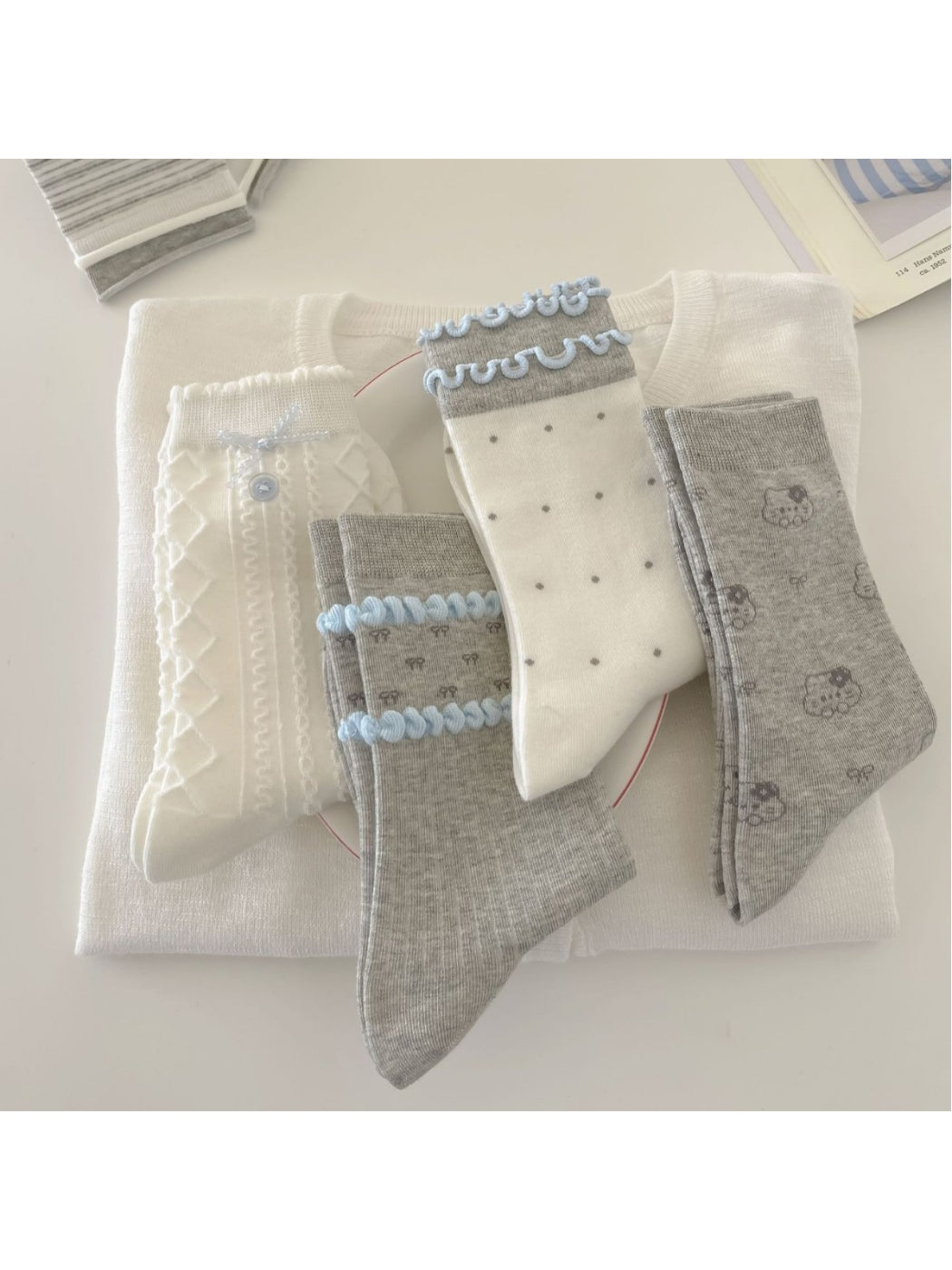 Pair of Rufia Dreamy Blue Trim Mixed Crew Socks laid flat showing blue trim and mixed patterns