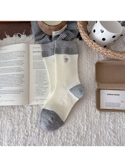 Rufia embroidered ribbon ribbed slouch socks displayed with focus on embroidered ribbon design