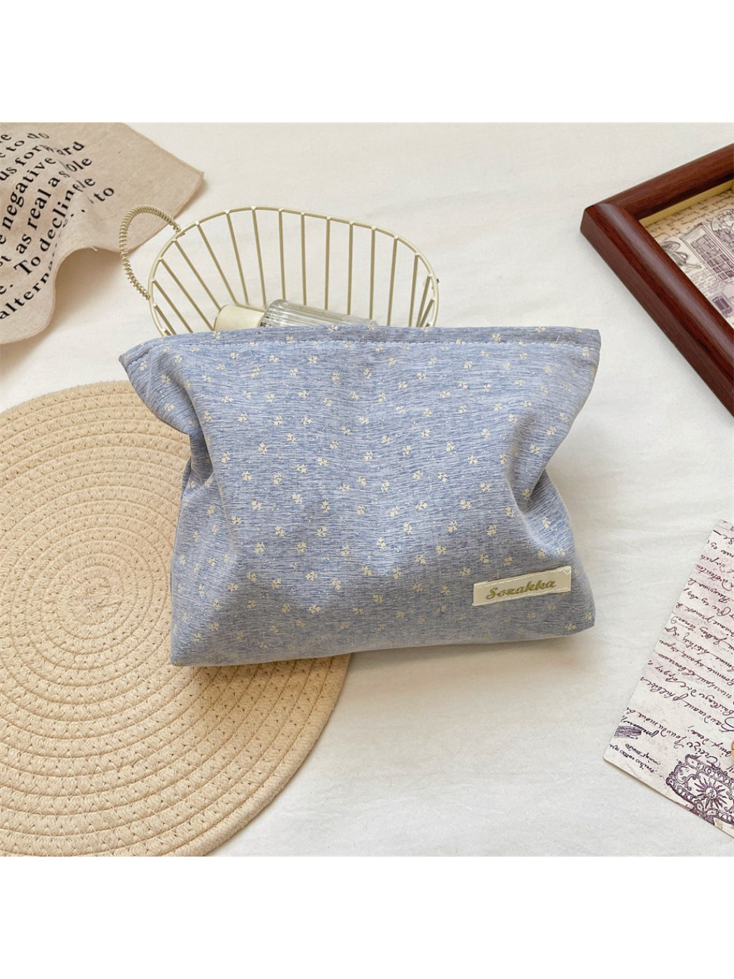 Cosbai vintage tiny flower cosmetic pouch placed next to makeup brushes