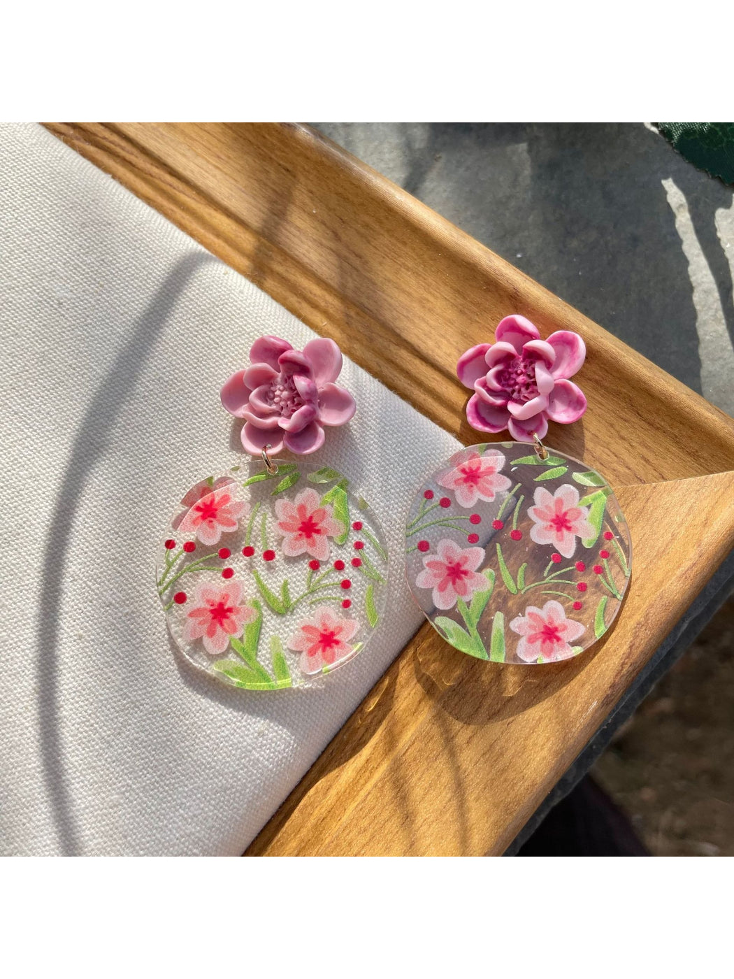 Close-up of Earwish Garden Flower Disc Earrings with floral design on white background