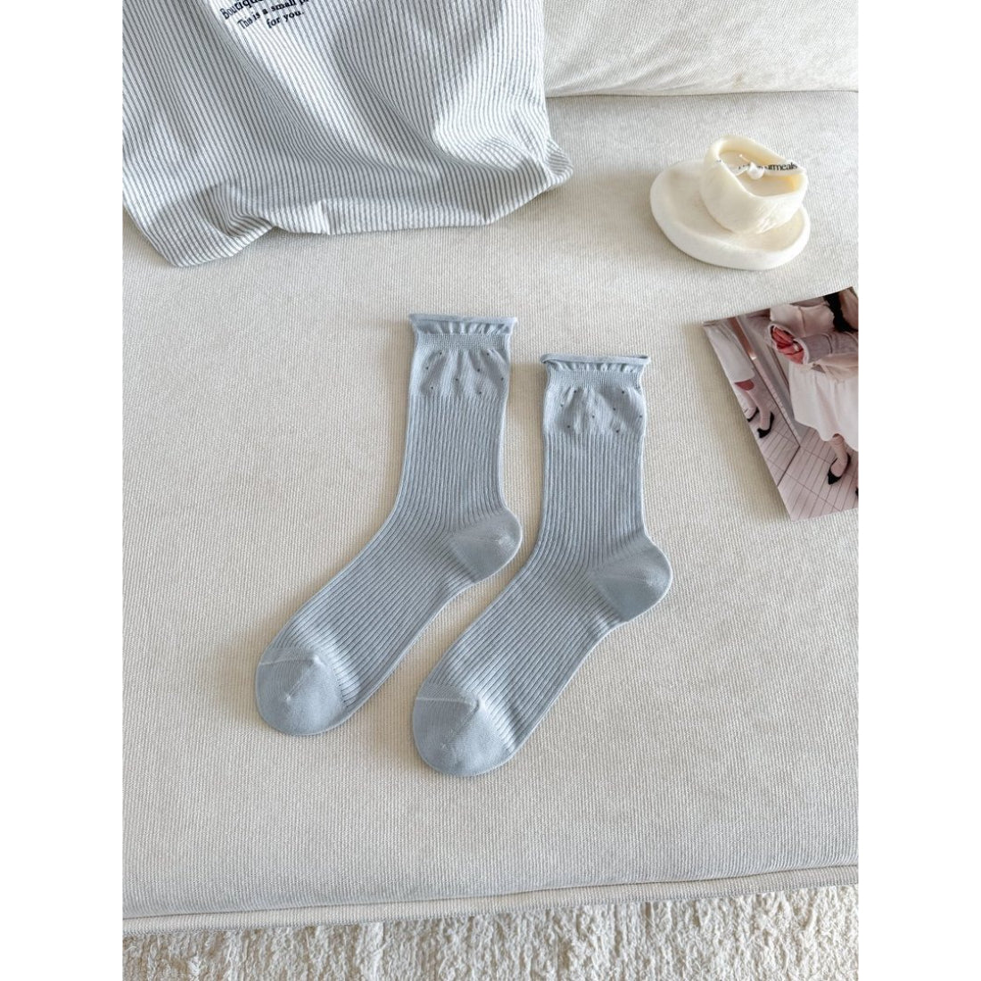 Pair of Rufia Everyday Turn Cuff Knit Socks folded neatly on wooden surface