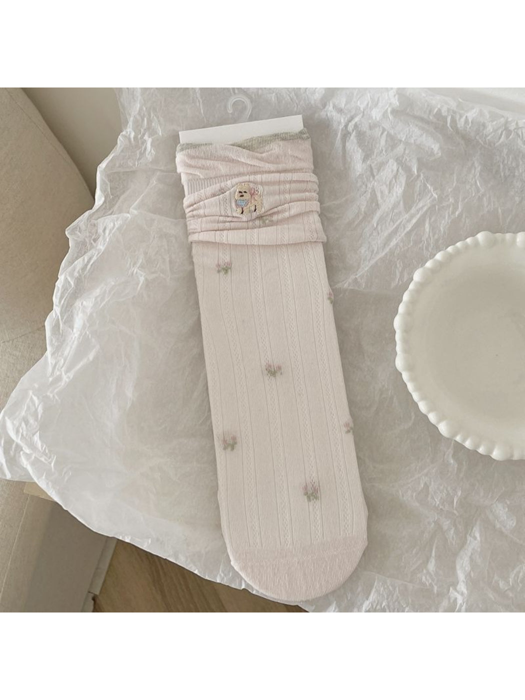 Rufia socks folded neatly showing the animal detail pattern and brand tag