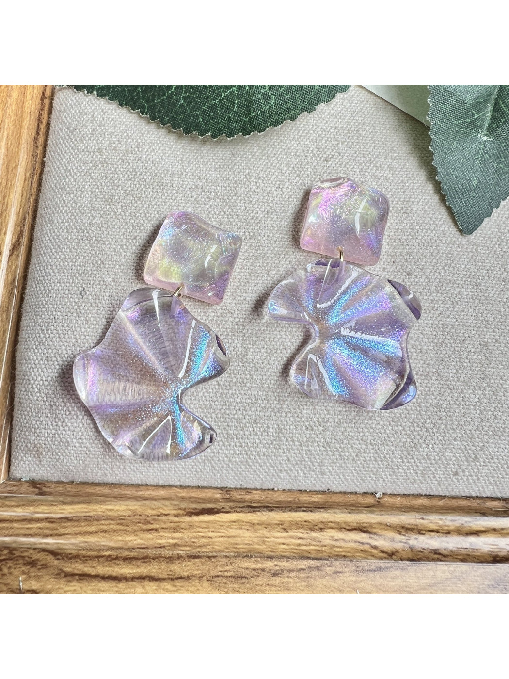 Side view of Earwish purple flower drop earrings showing detailed petals
