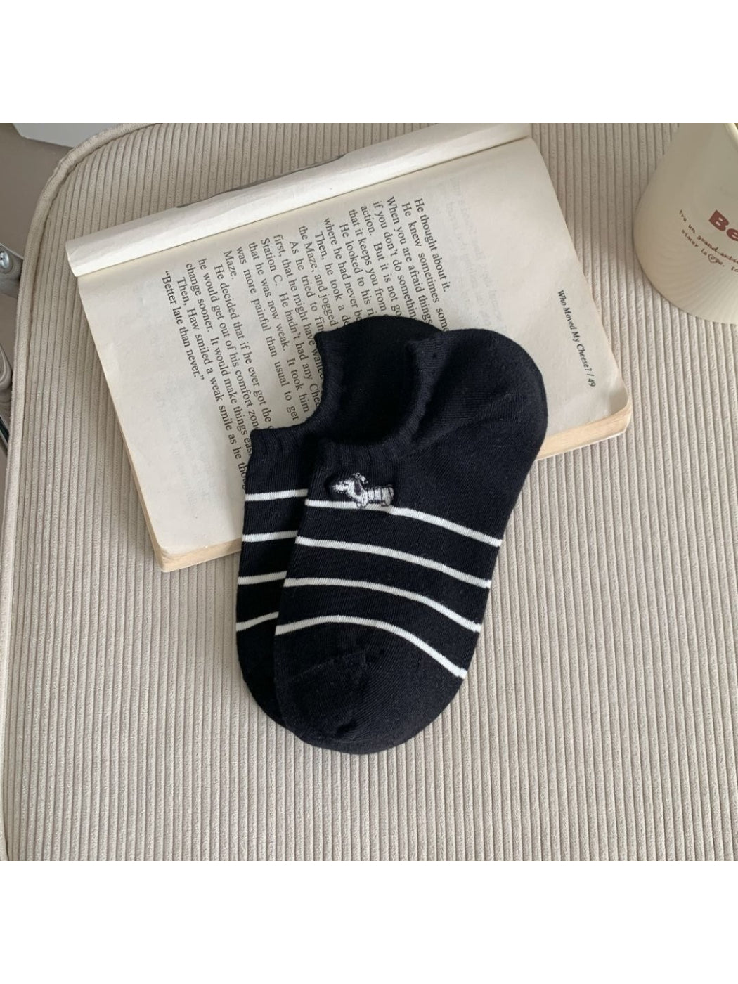 Rufia Dog Stripe No Show Socks in white with black dog stripe pattern folded neatly