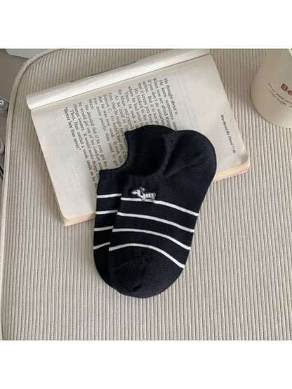 Rufia Dog Stripe No Show Socks in white with black dog stripe pattern folded neatly