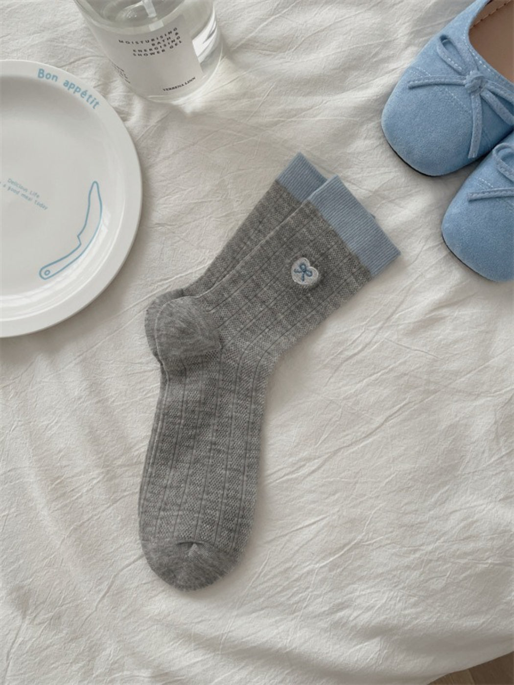 Rufia lightweight floral knit crew socks displayed on wooden surface with soft lighting