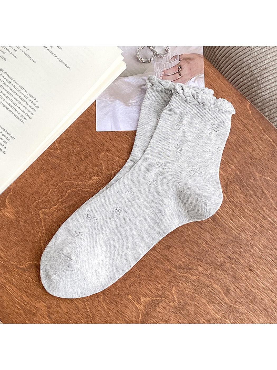Close-up of cream knit sock showing bow detail and knit texture