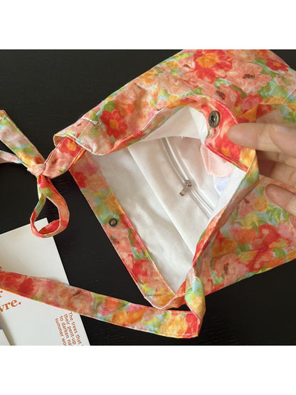 Cosbai Painterly Bloom shoulder bag with dog charm hanging, showing hardware details