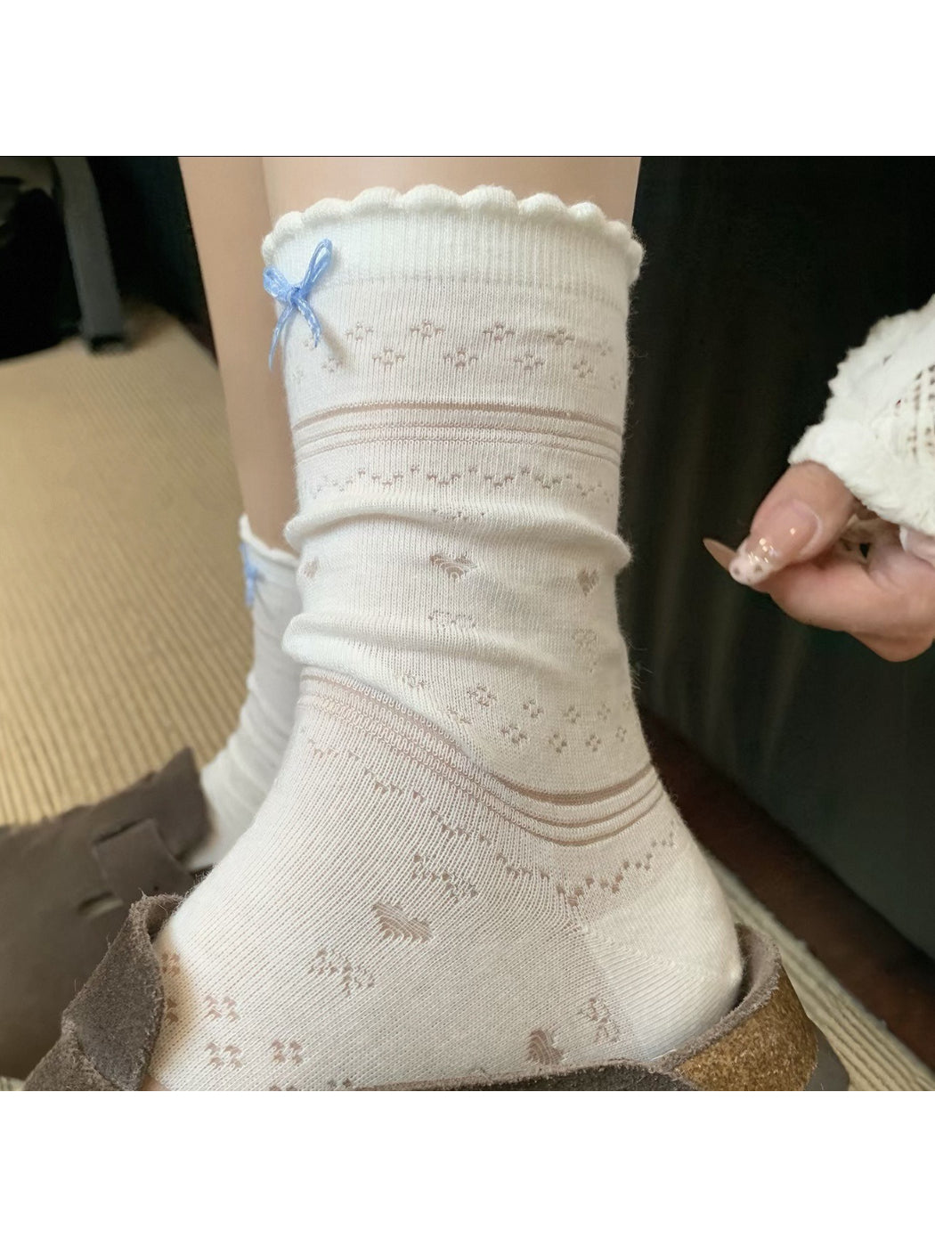 Side view of soft blue ribbon socks highlighting fabric texture