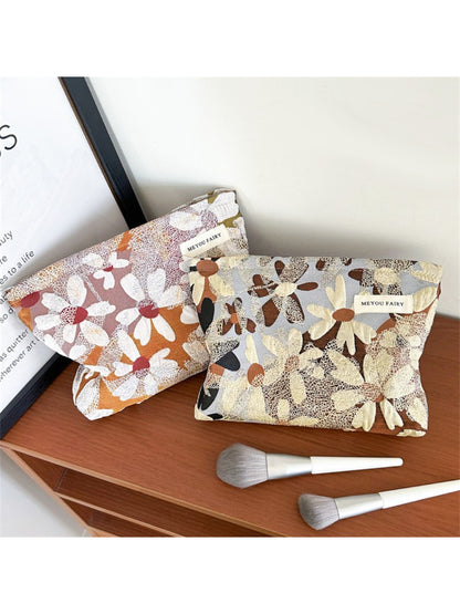 Cosbai makeup bag standing upright showing warm floral design