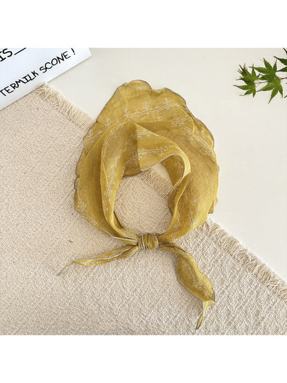 Model wearing Scarvii lightweight textured tie head scarf styled as a headband
