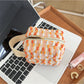 Cosbai woven stripe cosmetic bag standing upright with visible zipper on top