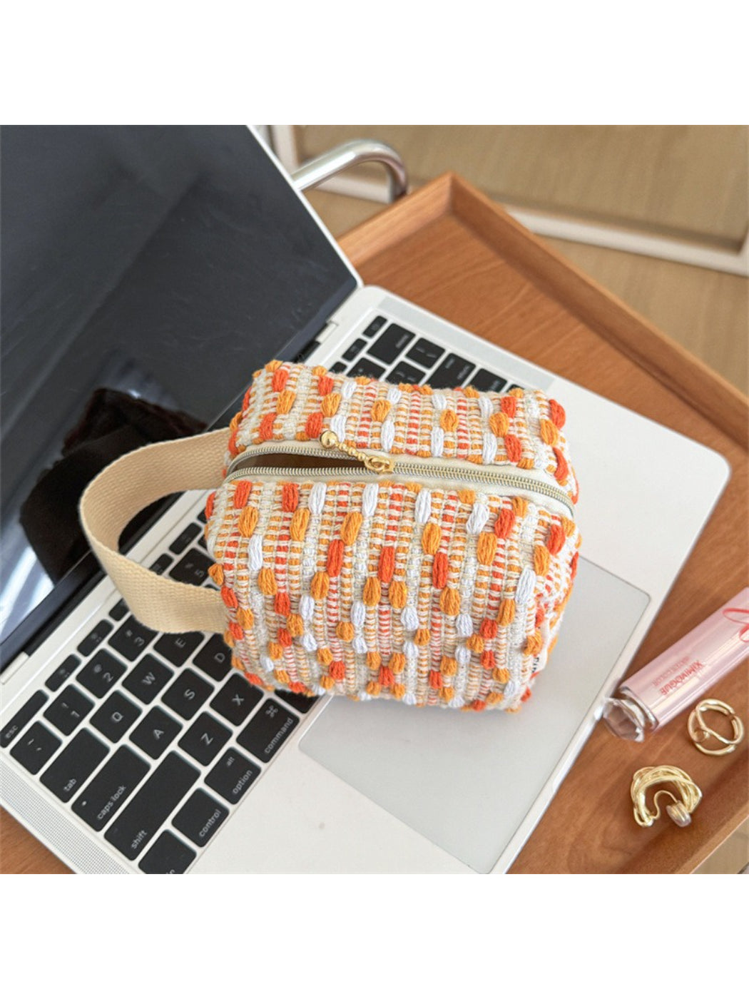 Cosbai woven stripe cosmetic bag standing upright with visible zipper on top