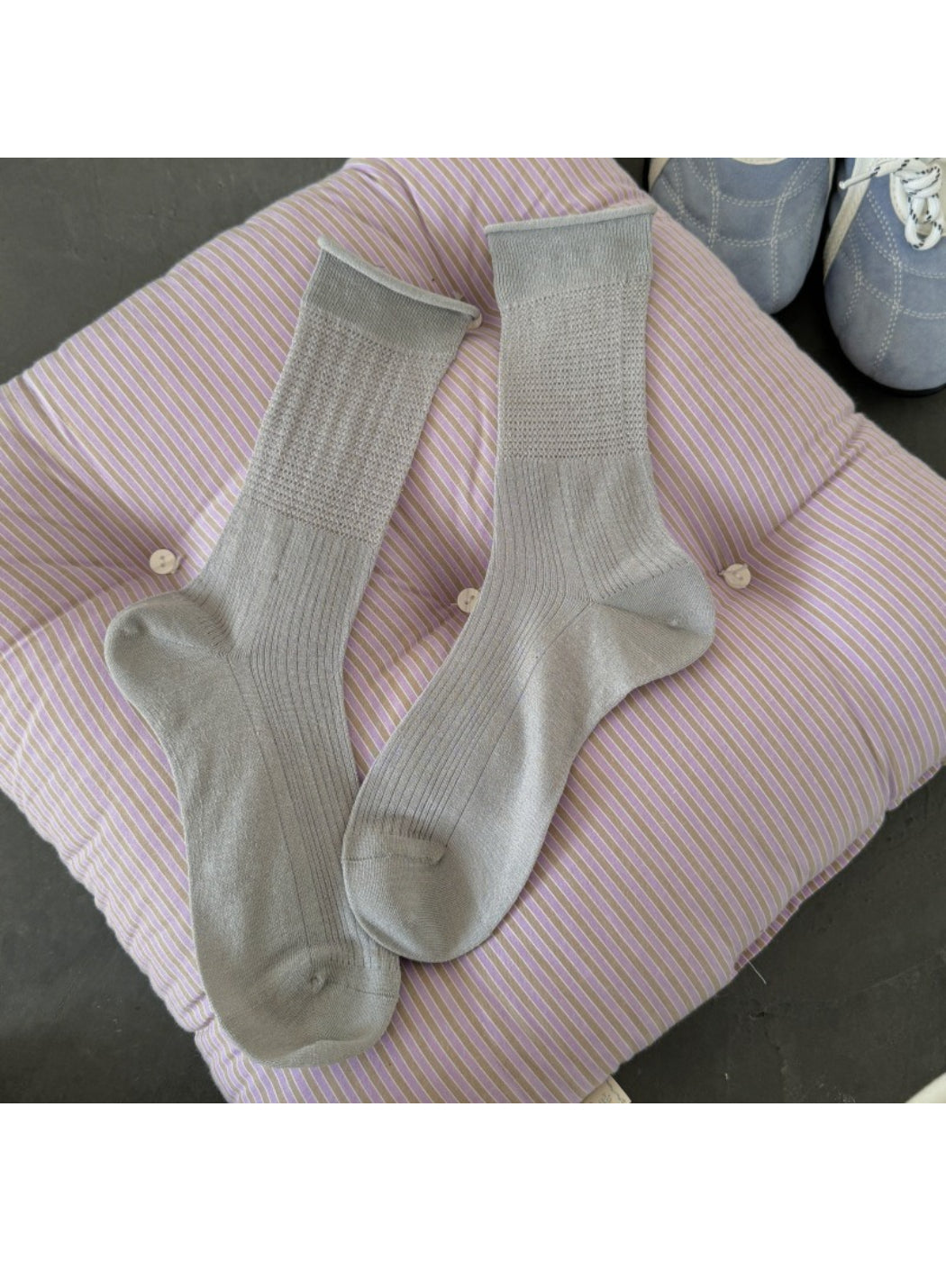 Stack of Rufia soft knit everyday crew socks in various neutral colors