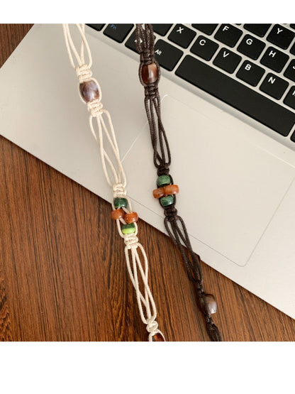 Close-up of belt ends showing beadwork and tie closure