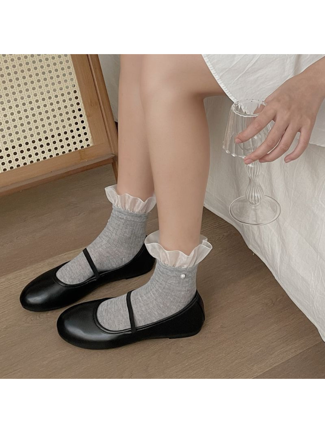 Pair of Rufia sheer crew socks with ruffle trim in white displayed flat