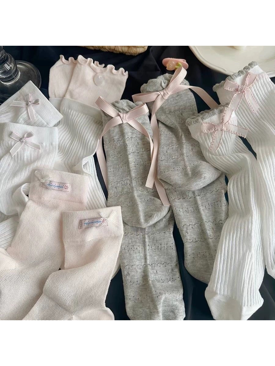 Close-up of Rufia Romantic Bow Texture crew socks in soft pink with bow detail