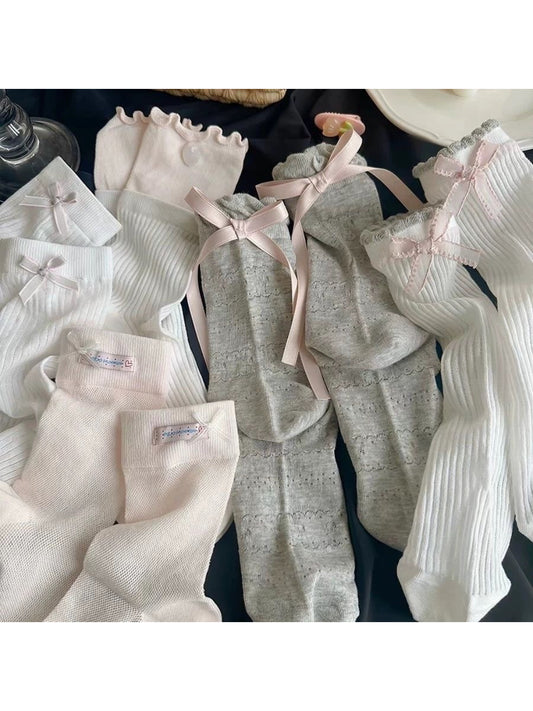 Close-up of Rufia Romantic Bow Texture crew socks in soft pink with bow detail