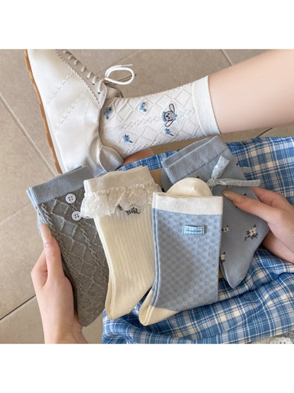 Pair of Rufia Sweet Blue Grey crew socks displayed flat on white background