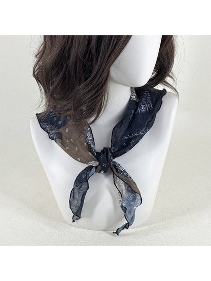 Scarvii sheer triangle scarf laid flat highlighting black and white bandana design