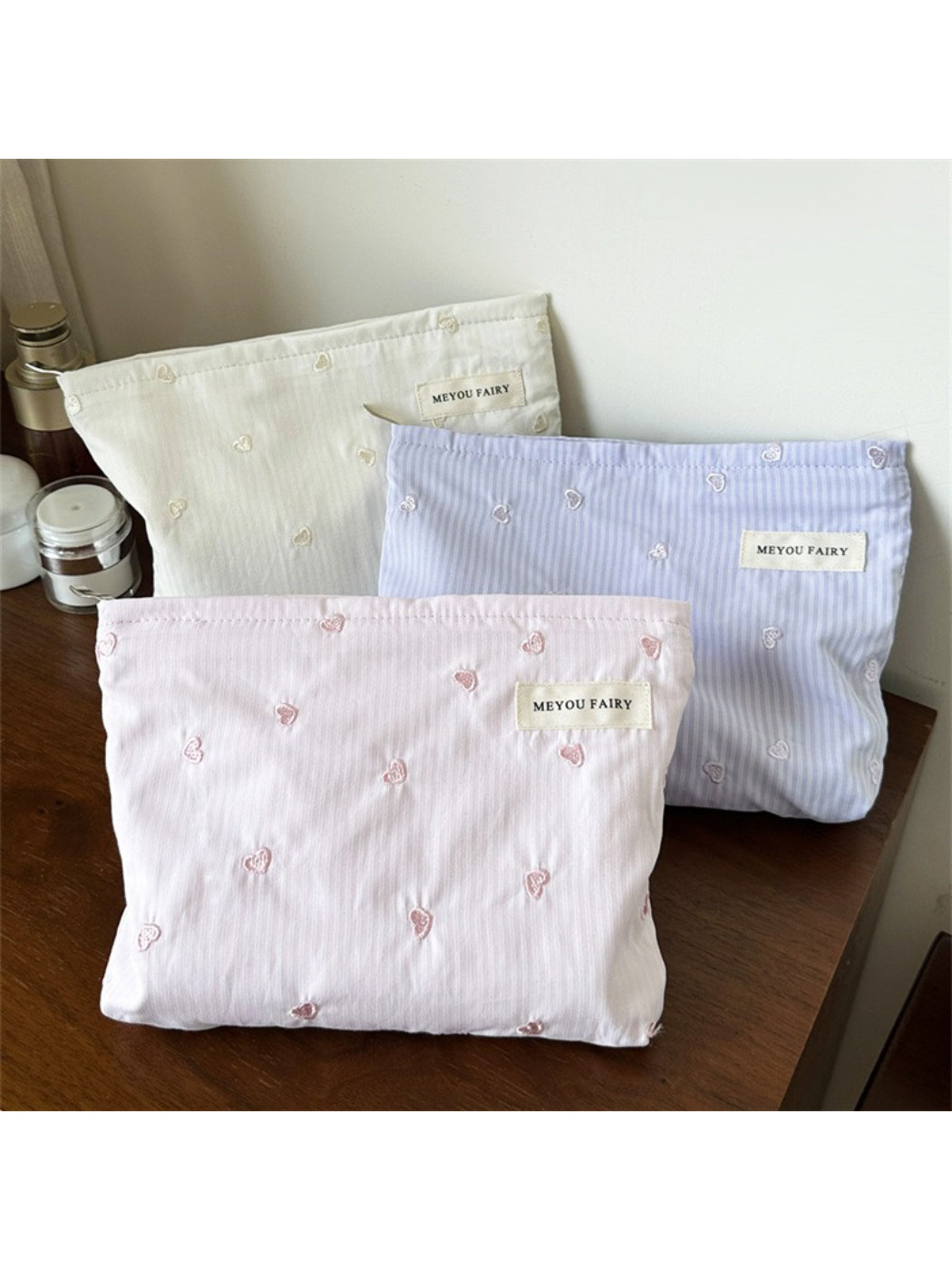 Close-up of the soft striped fabric and heart design on the Cosbai makeup organizer bag
