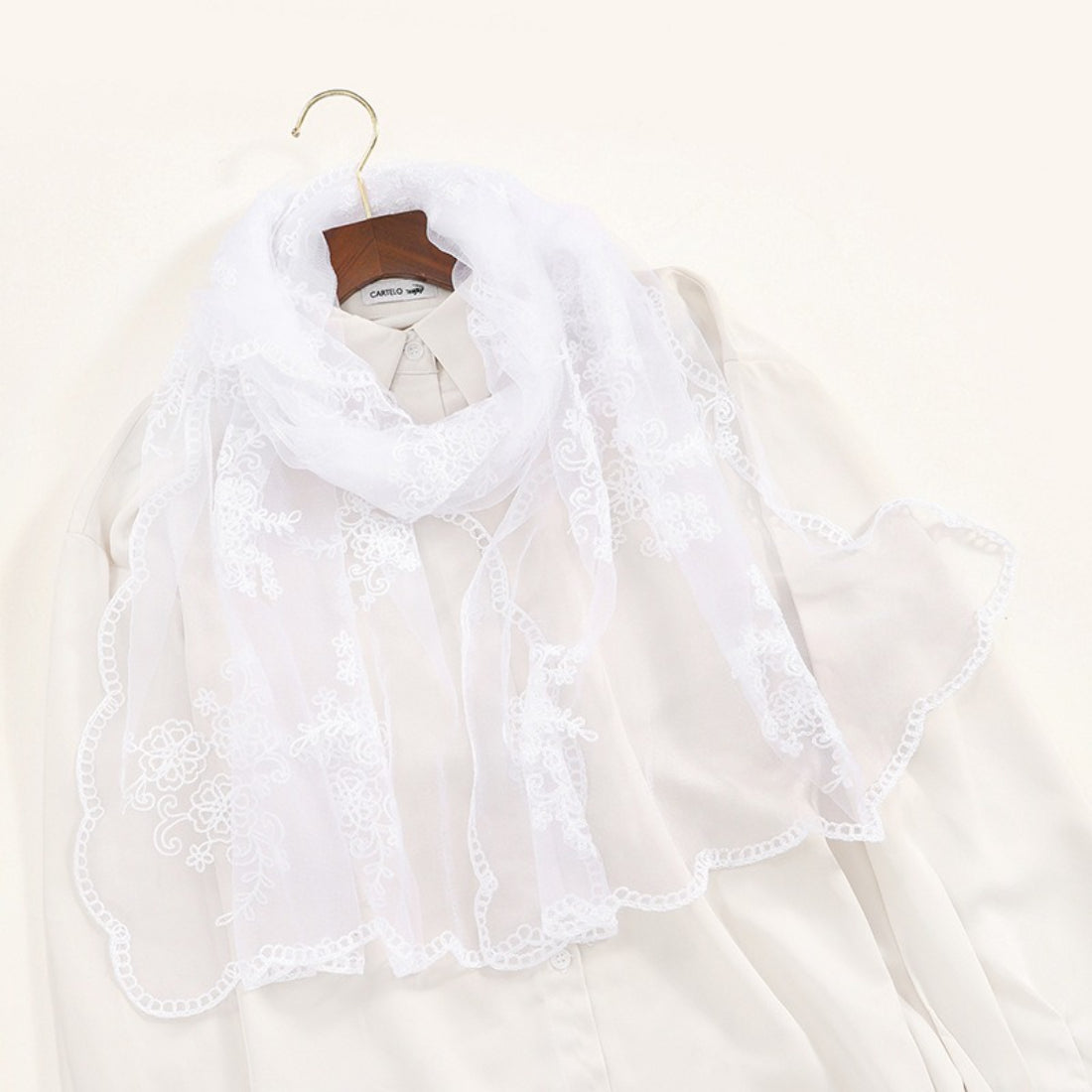 Close-up of delicate baroque embroidery on sheer Scarvii scarf fabric