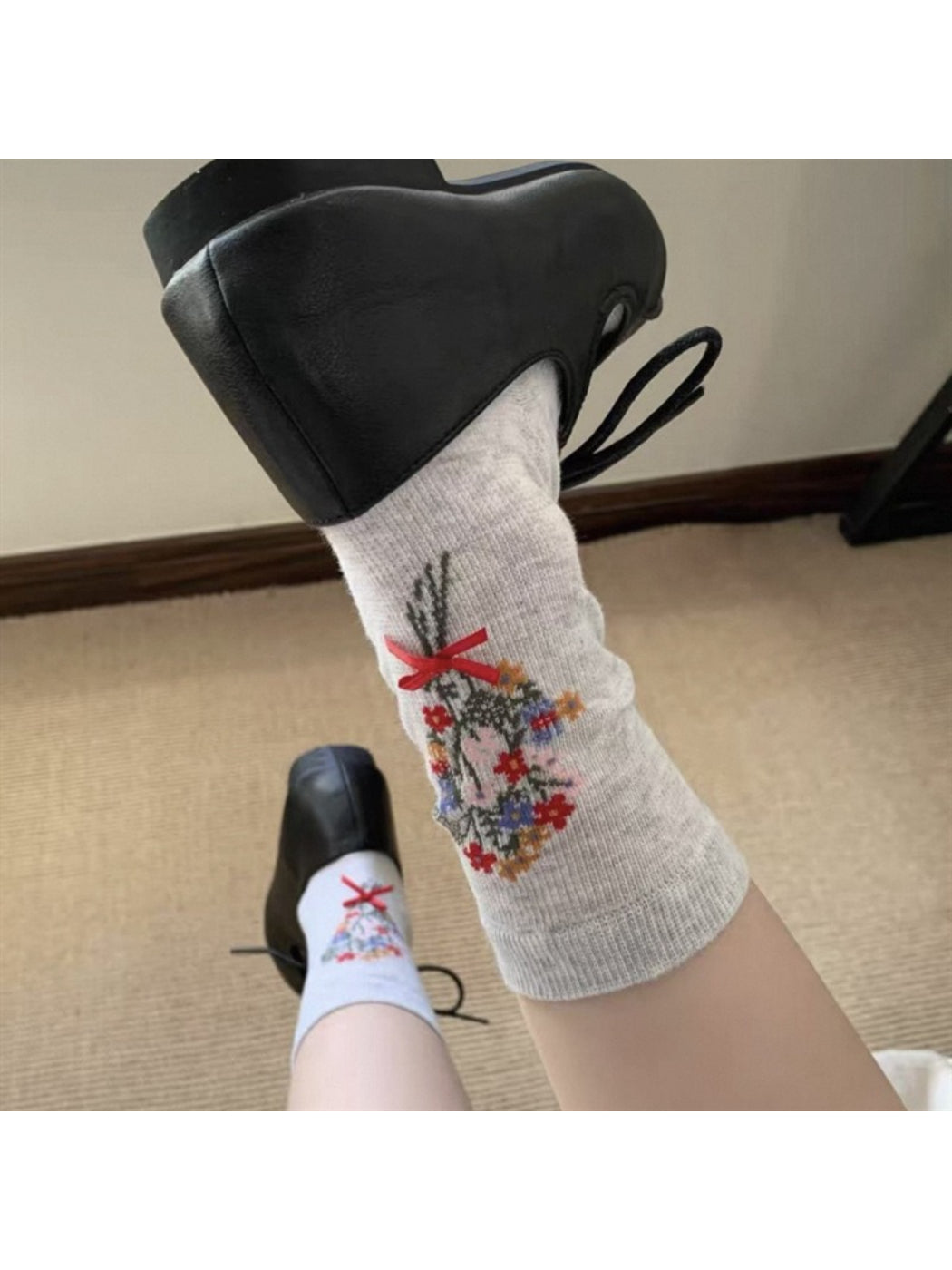 Pair of Rufia floral bow ankle socks laid out to show full design