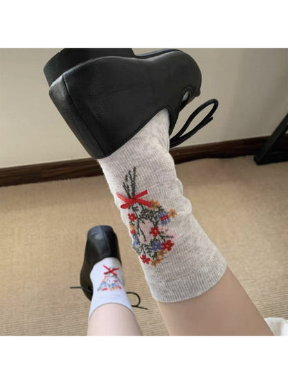 Pair of Rufia floral bow ankle socks laid out to show full design