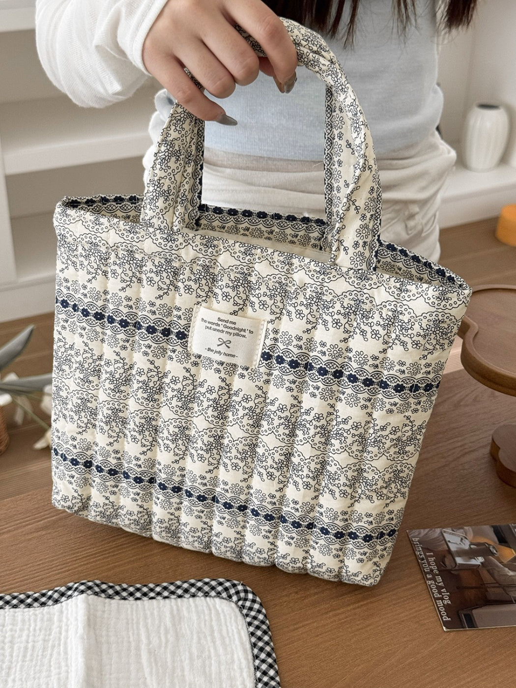 Cosbai tote bag with pastel garden pattern held by a model outdoors