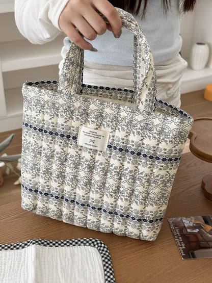Cosbai tote bag with pastel garden pattern held by a model outdoors