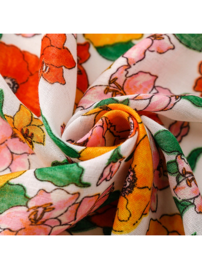Close-up of floral scarf fabric gathered into a twist