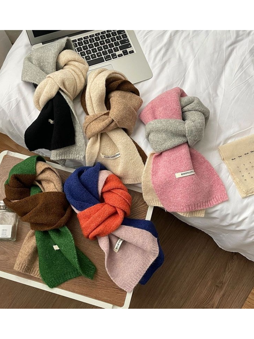 Five color-block scarves displayed together in looped arrangements