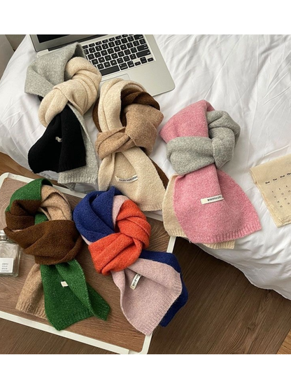 Five color-block scarves displayed together in looped arrangements
