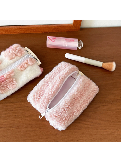 Open Stripes makeup bag showing pale pink lining, with part of Flowers beside it