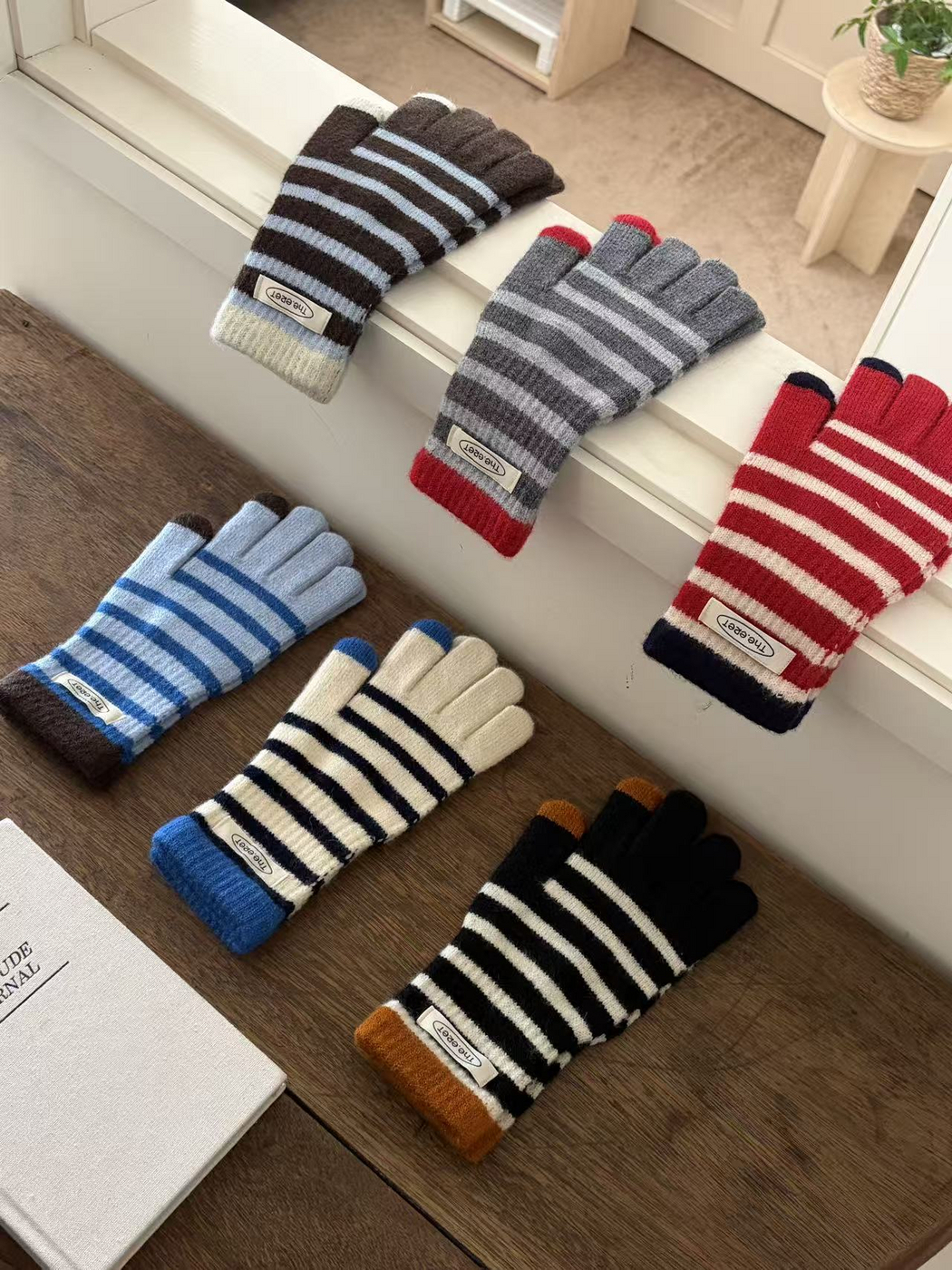 Gray, Red, Blue, Ivory, Black and Brown striped gloves displayed together