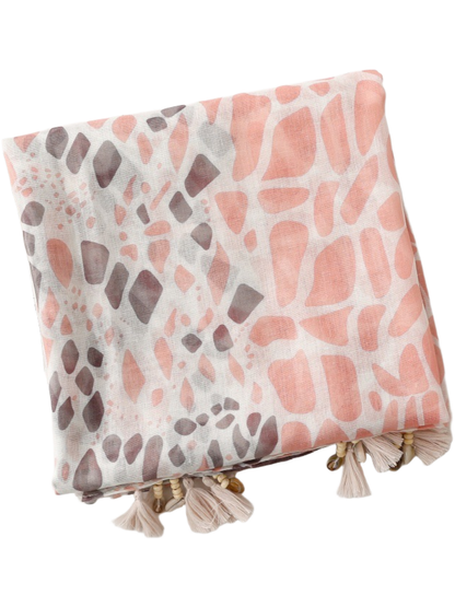 Folded scarf showing pink and brown irregular spots with tassel trim along the lower edge