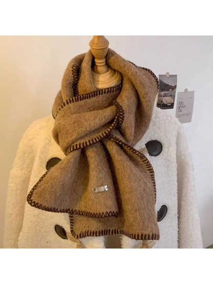 Camel scarf looped around a mannequin with both stitched ends visible