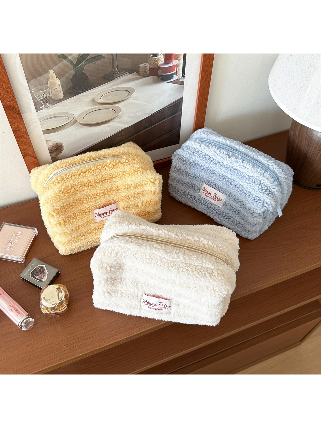 Yellow, Light Blue and Ivory cosmetic pouches arranged together with their tops visible