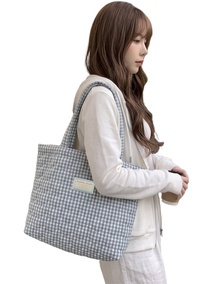 Light Blue gingham tote hanging at the side, outdoor carry view