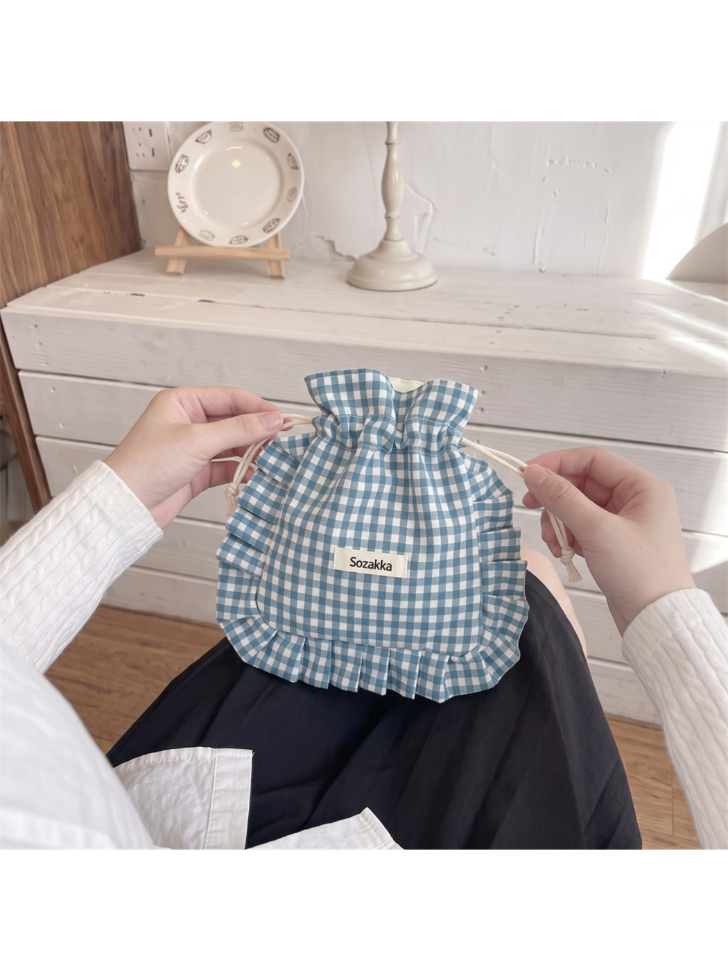 Teal Blue gingham drawstring pouch held with both cords extended