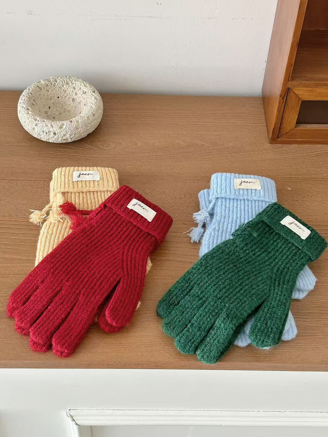 Yellow gloves showing both sides with assorted ribbed gloves behind