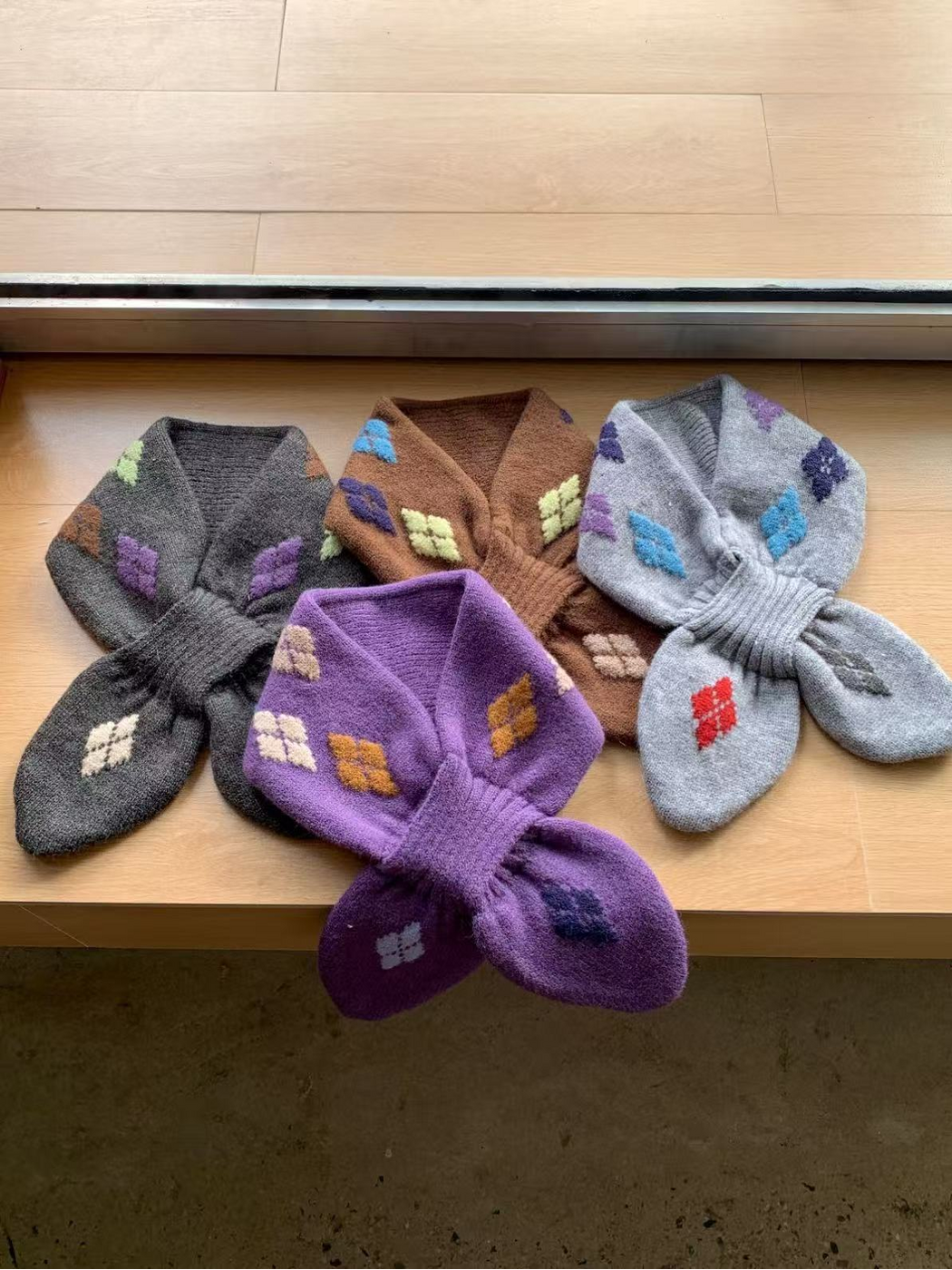Dark Gray, Brown, Light Gray and Purple scarves arranged together with Purple in front