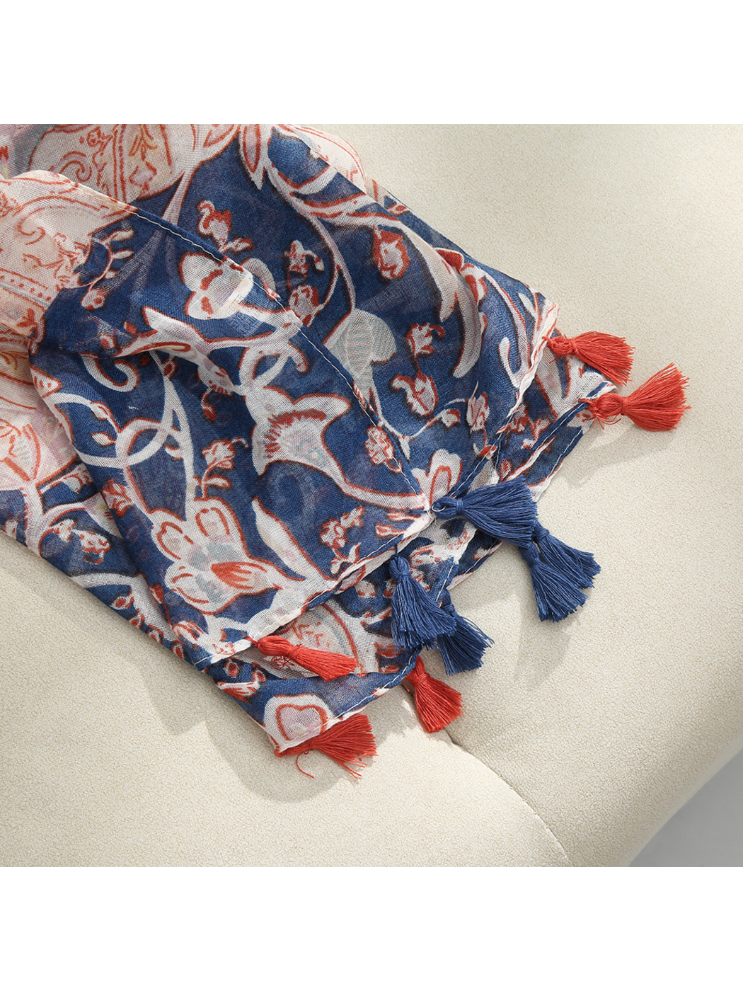 Close-up of the patterned scarf edge with red and navy tassels
