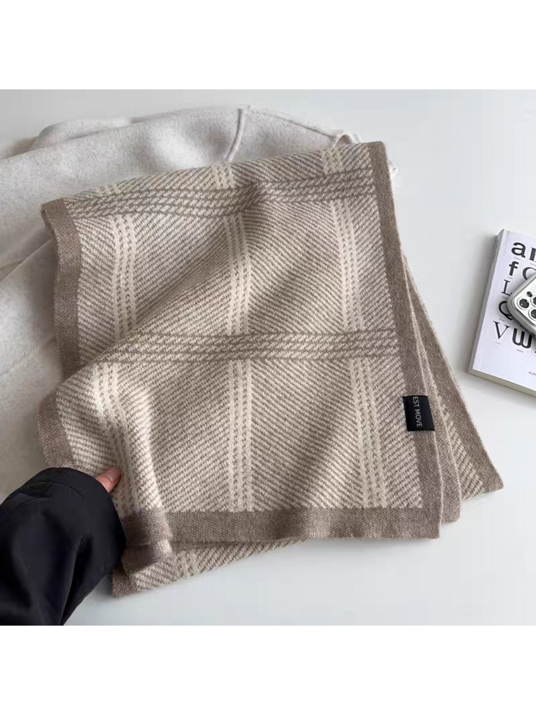 Beige plaid scarf folded to show its taupe border and attached label