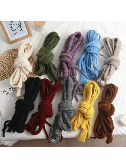 Fuzzy narrow scarves in several colors folded and tied in loose knots