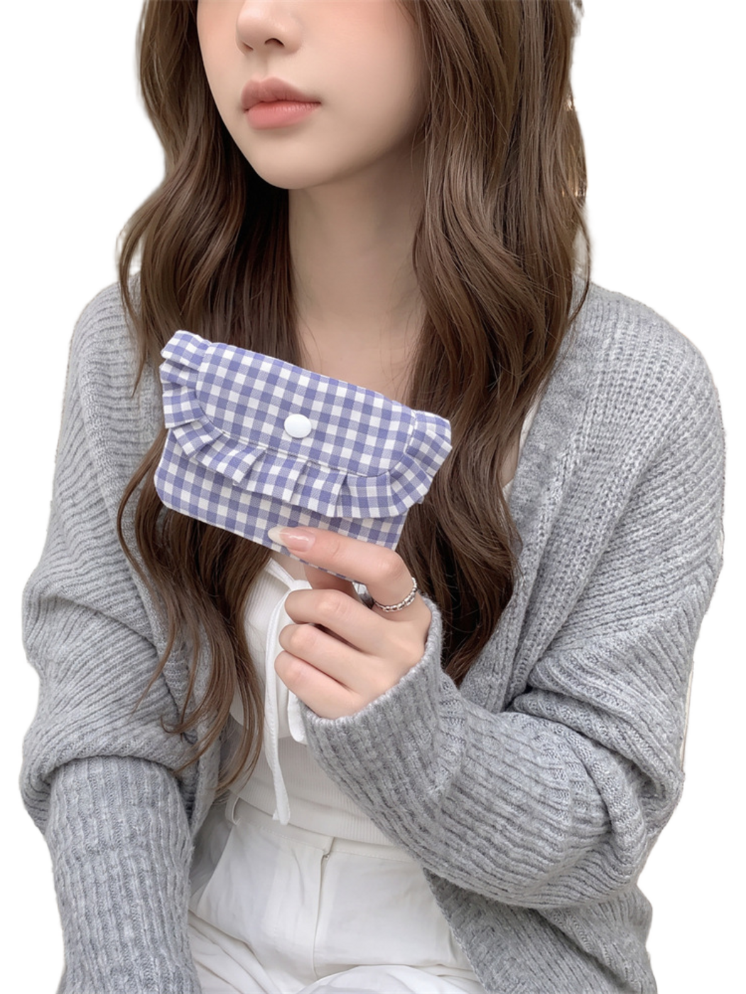 Purple gingham coin purse tilted in one hand, showing the pleated ruffle and white snap